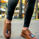 Tan casual sneakers on feet, back and side view, buckle strap detail