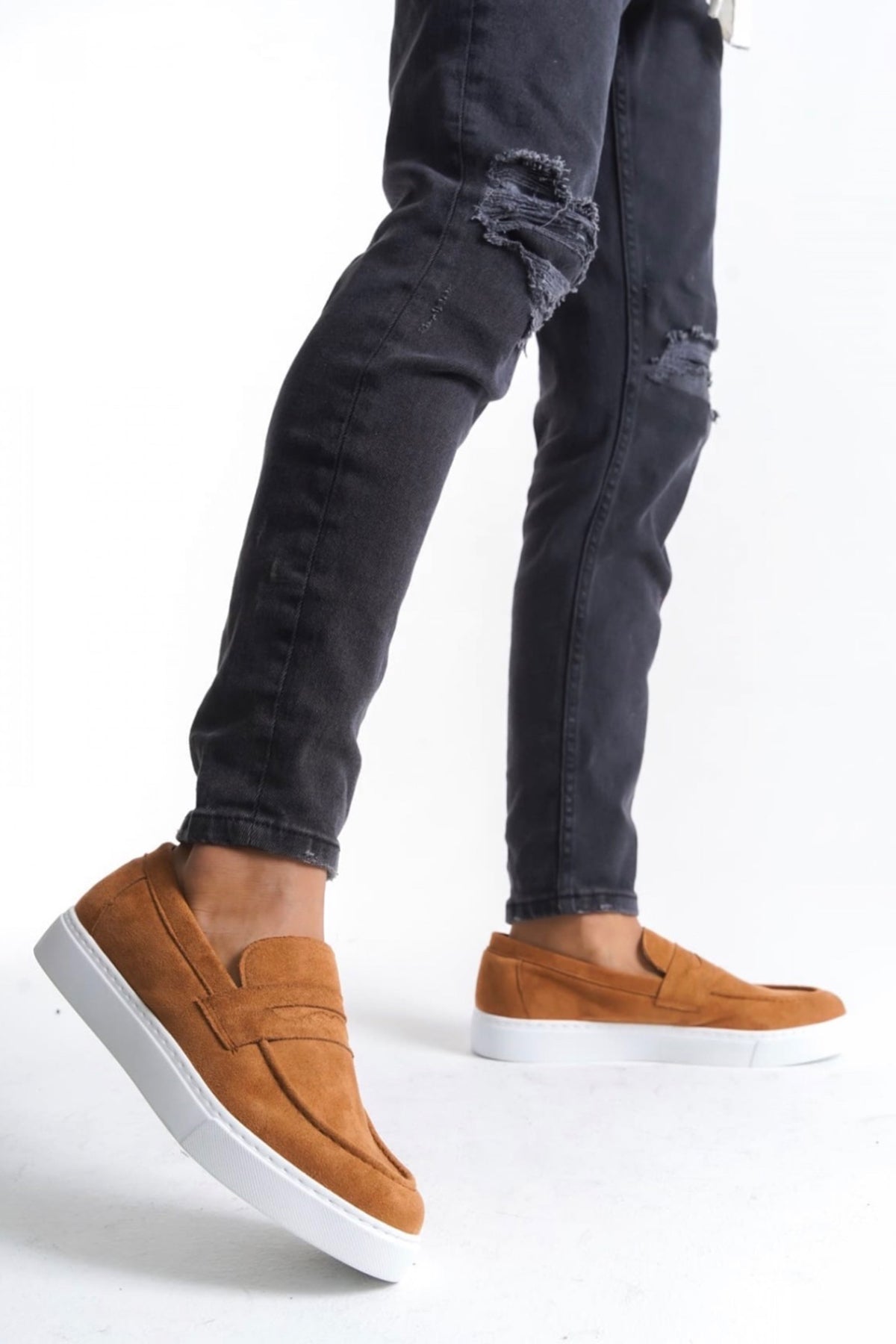 Men's tan suede slip-on loafers with white rubber sole