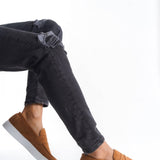 Men's tan suede loafers with moc stitching and white sole, side view
