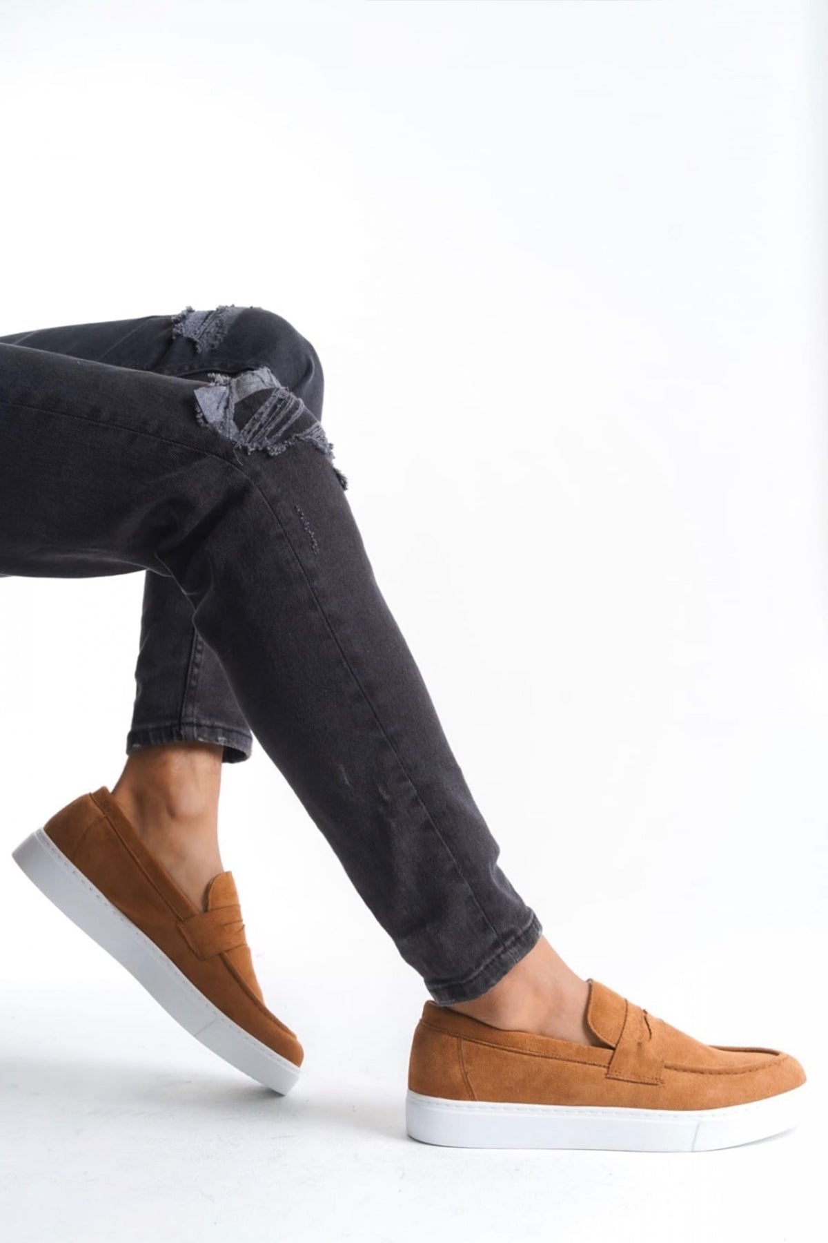 Men's tan suede loafers with moc stitching and white sole, side view