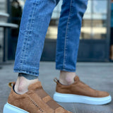Men's tan suede slip-on sneakers with light blue rubber sole, side profile