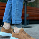 Men's tan suede slip-on sneakers with light blue rubber sole, rear side