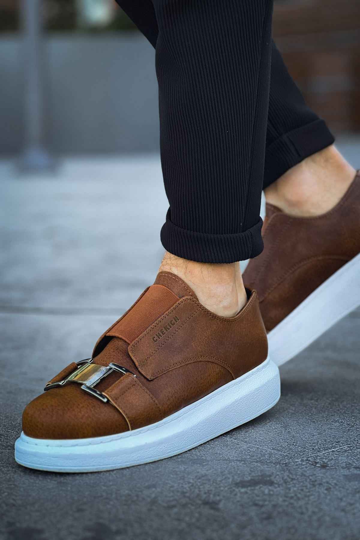 Men's casual tan suede sneakers, side view, white sole with buckle strap