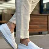 Men's casual white loafers, side profile with moc seam and slip-on upper