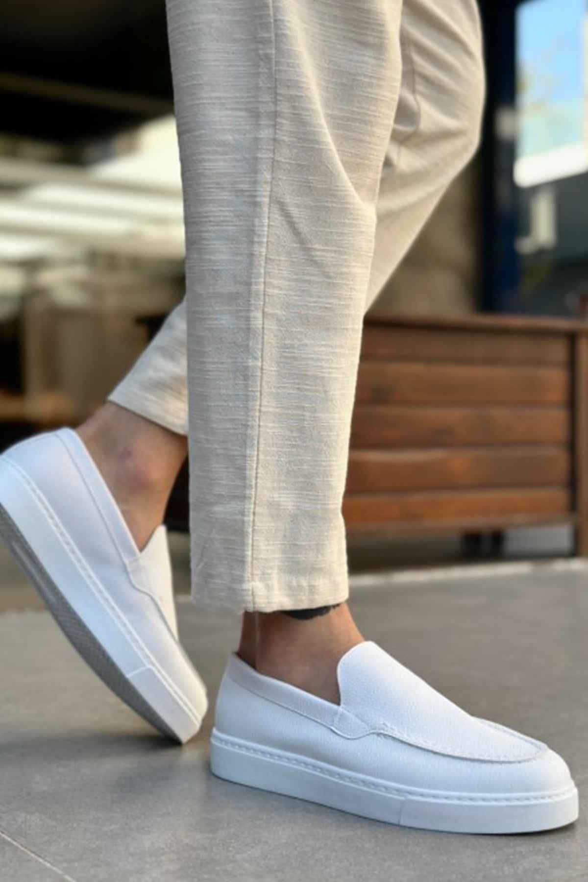 Men's casual white loafers, side profile with moc seam and slip-on upper