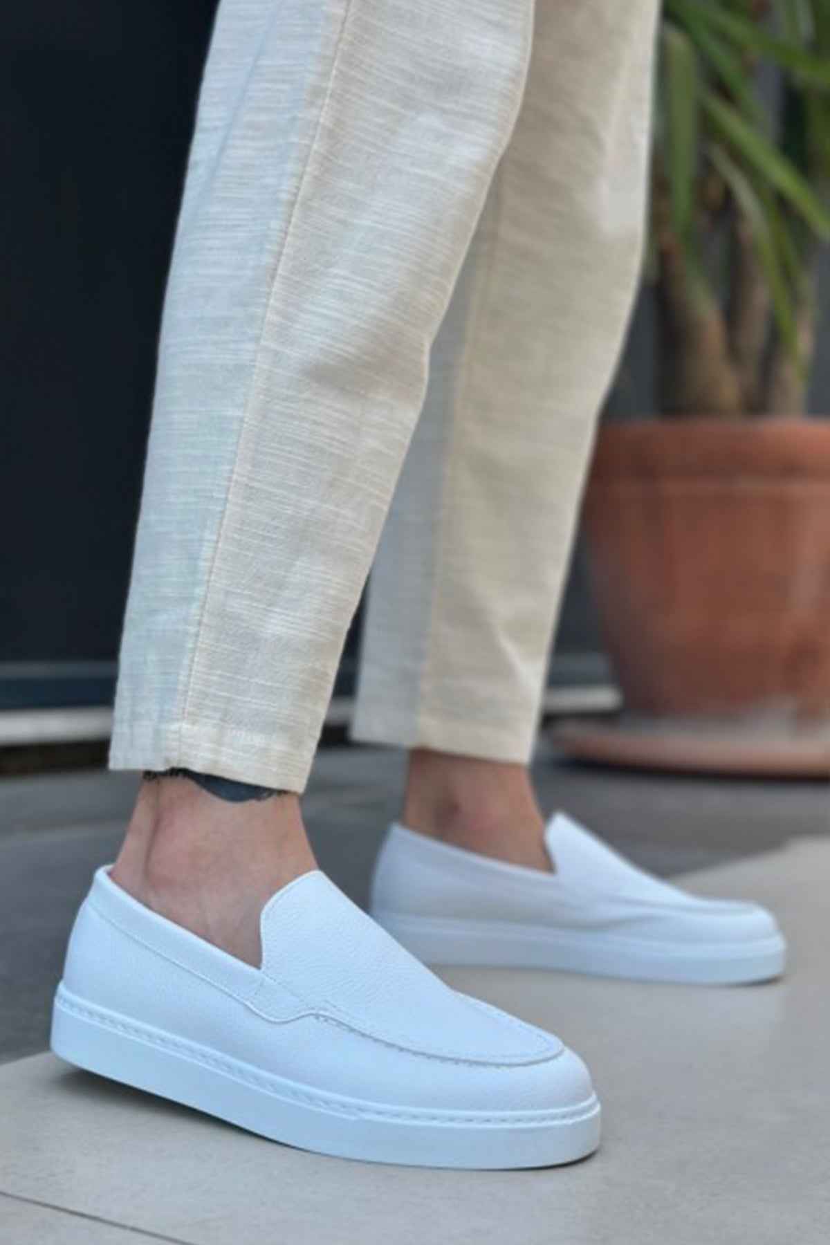 Men's casual white loafers, front angle with moc seam and stitched vamp