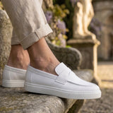 White men's slip-on loafers with side strap detail and smooth low-profile sole