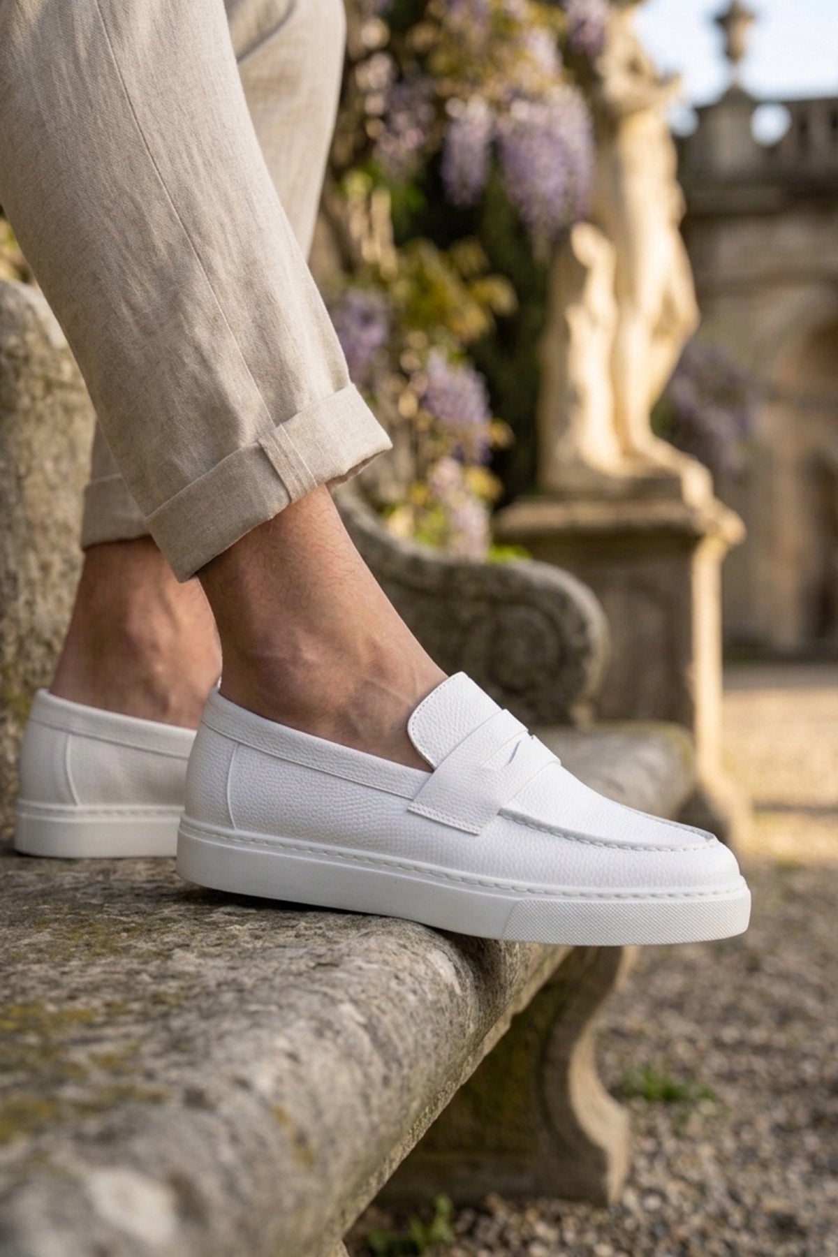 White men's slip-on loafers with side strap detail and smooth low-profile sole