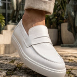 White leather-look men's loafers with strap, curved stitching, and thick sole
