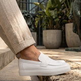 White men's casual loafers with side strap and stitched front, low platform sole