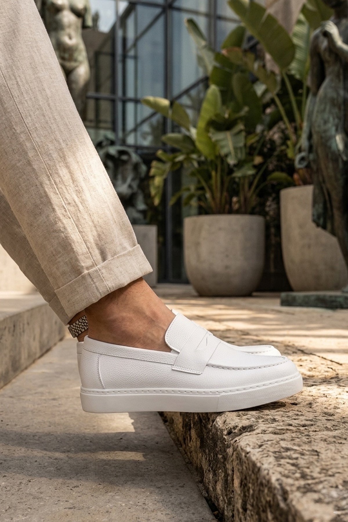 White men's casual loafers with side strap and stitched front, low platform sole