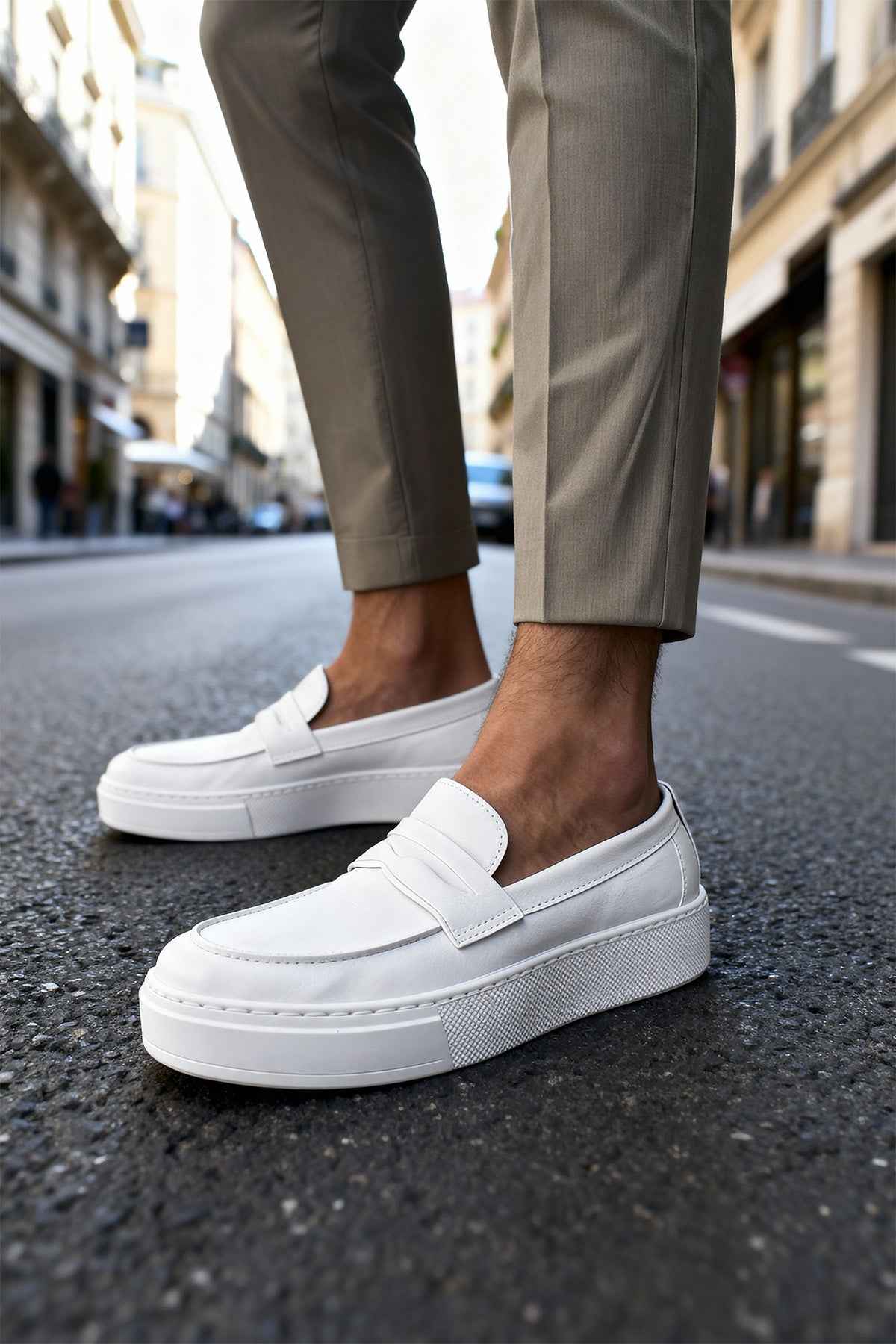 Men's white loafers with strap and stitched sole, close side view
