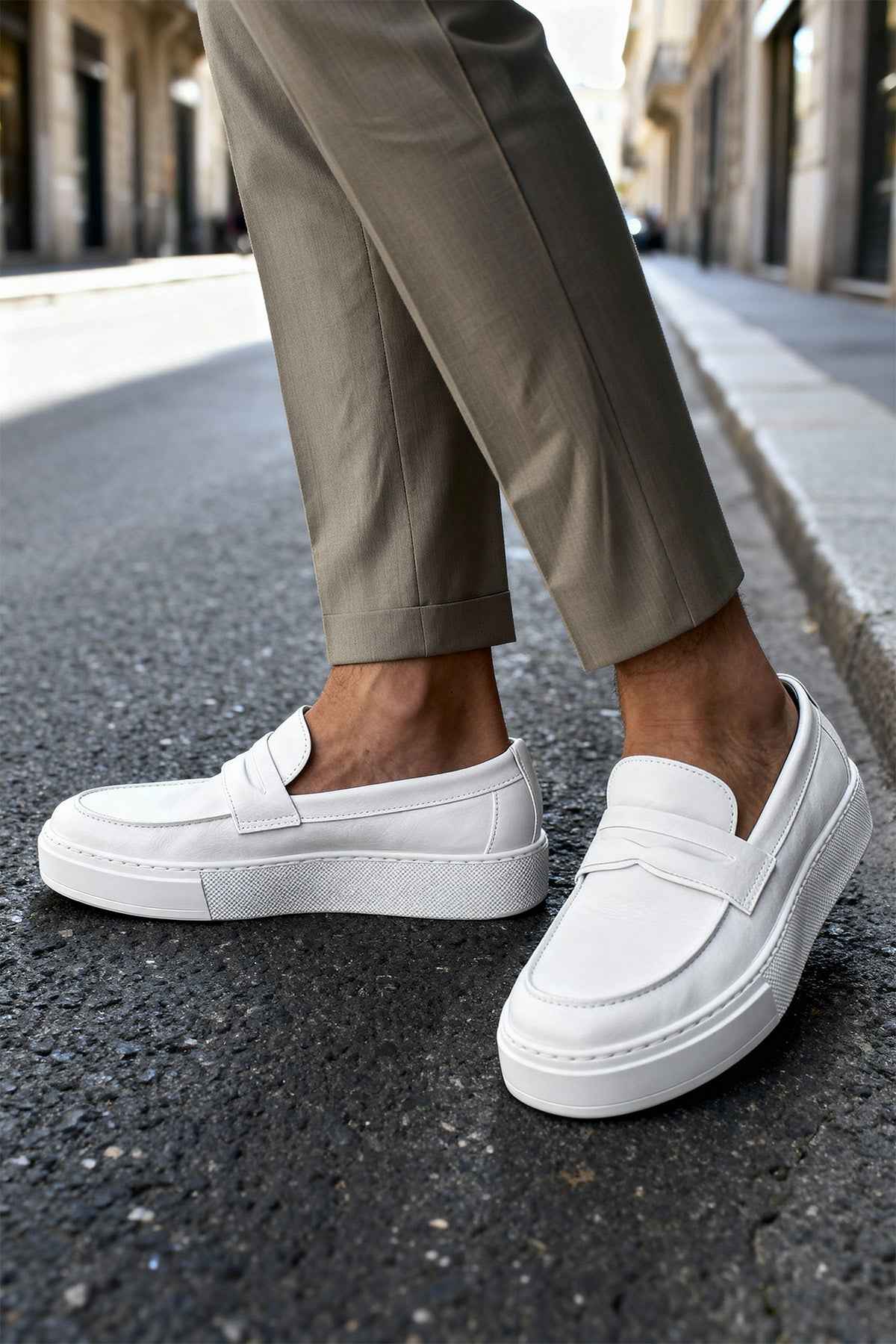 Men's casual white loafers, side view with stitched vamp and slip-on strap