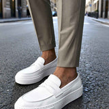 Men's casual white loafers, front three-quarter view with slip-on strap