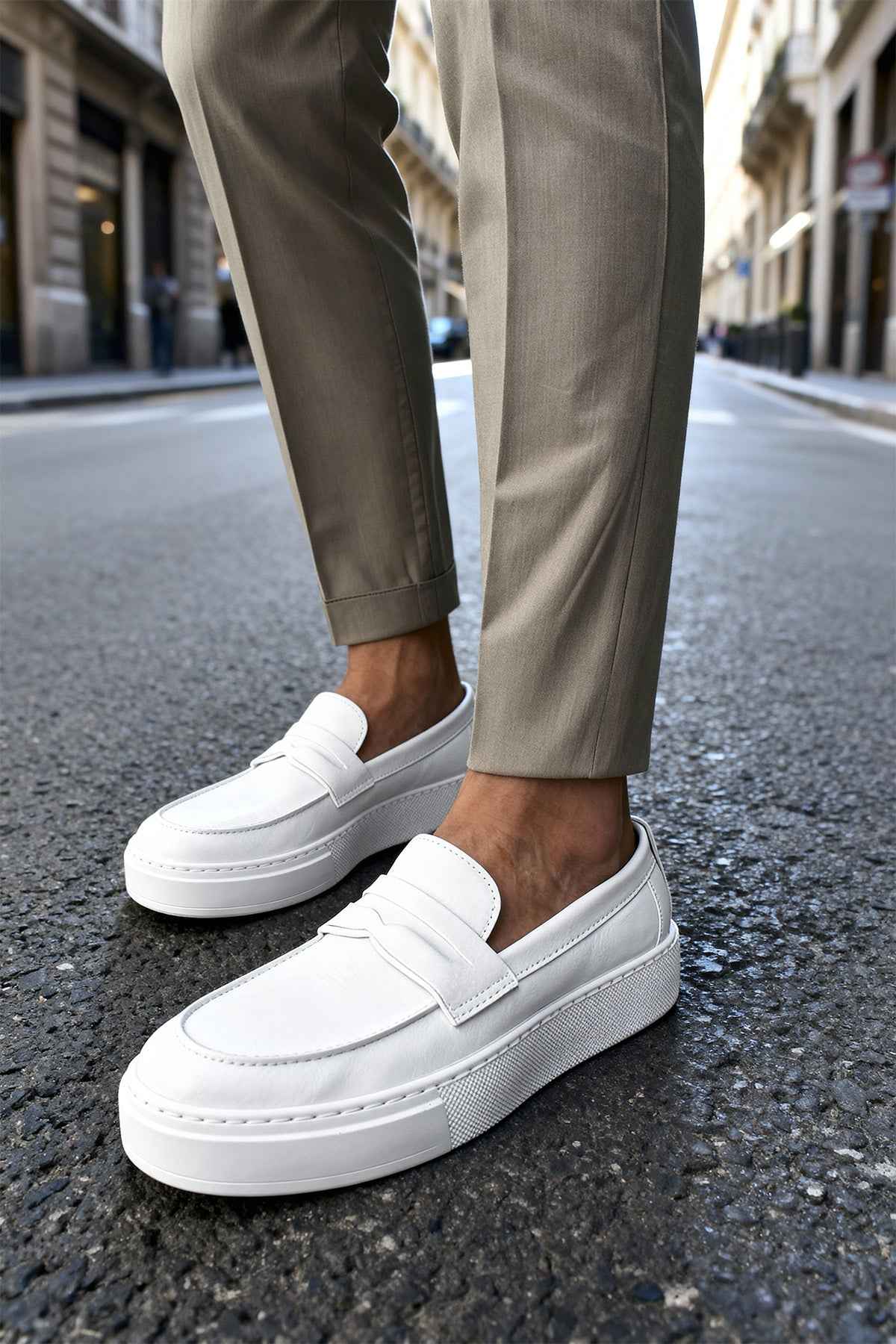 Men's casual white loafers, front three-quarter view with slip-on strap