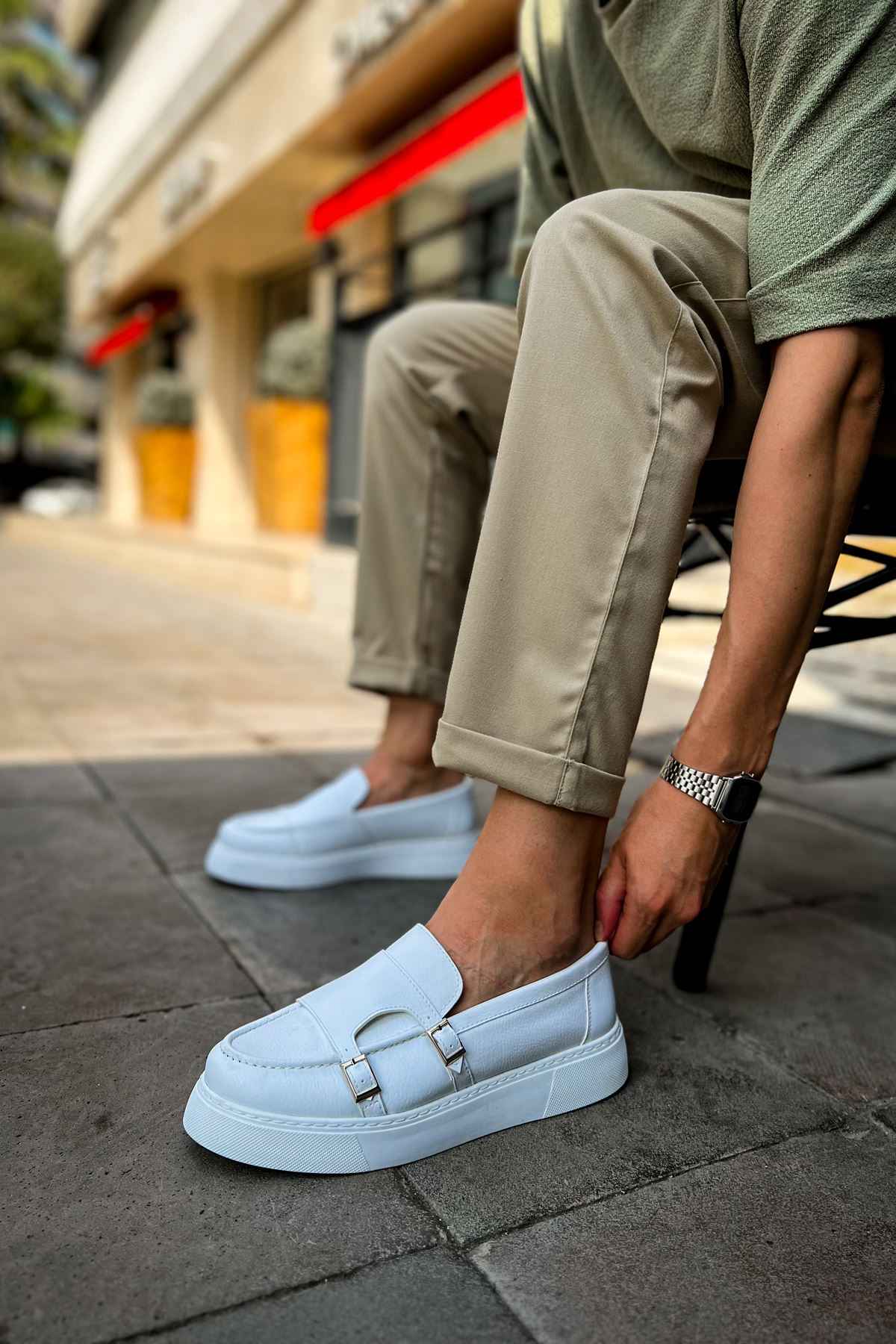 Men's casual light blue loafer with metal buckle strap, front angle