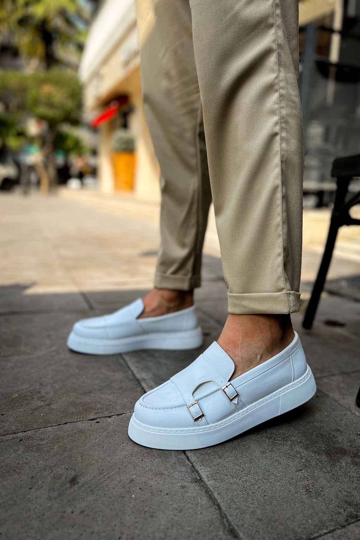 Men's casual light blue loafer with buckle strap, front profile view