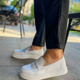 Men's white loafer shoe, side profile with thick rubber sole