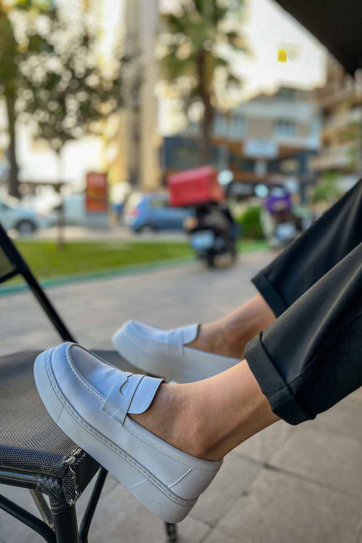 Men's white loafer with strap across instep and cushioned insole