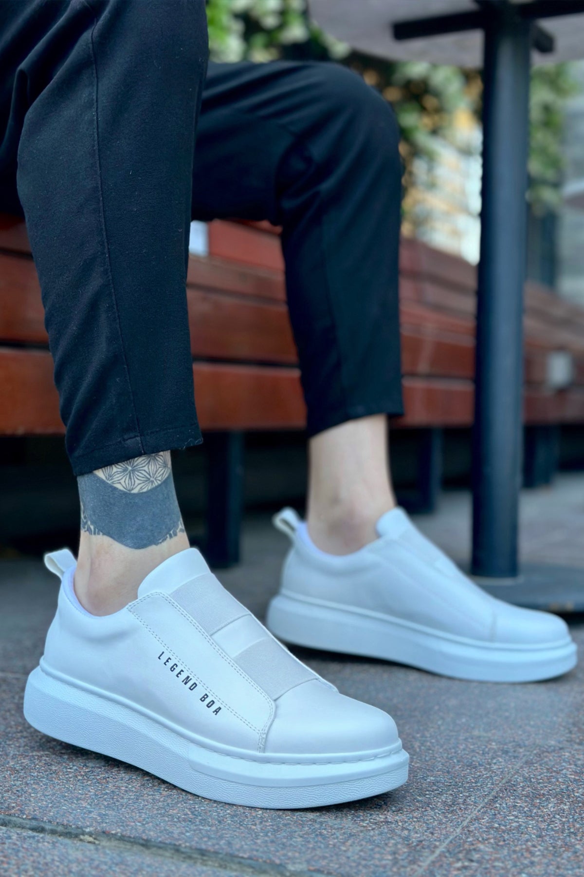 Men's low-top white slip-on sneakers with side logo and rubber sole