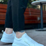 Men's low-top white slip-on sneakers, side view, thick rubber sole