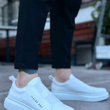 Men's low-top white slip-on sneakers, front and side view, rubber sole