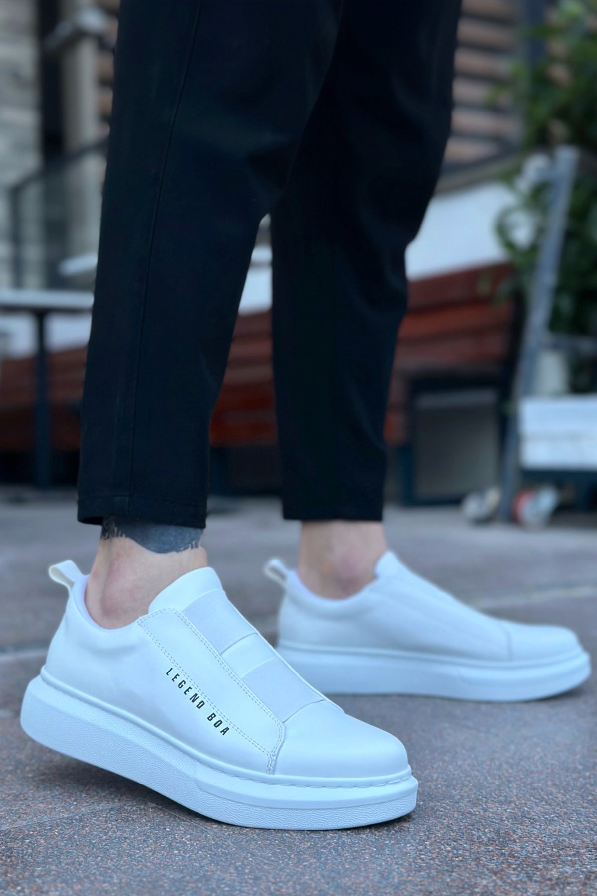 Men's low-top white slip-on sneakers, front and side view, rubber sole