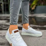 White lace-up casual sneakers with brown logo tag