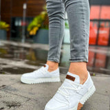 White lace-up sneakers with textured sole and brown side accents