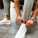 Men's white lace-up sneakers with perforated toe and cushioned collar