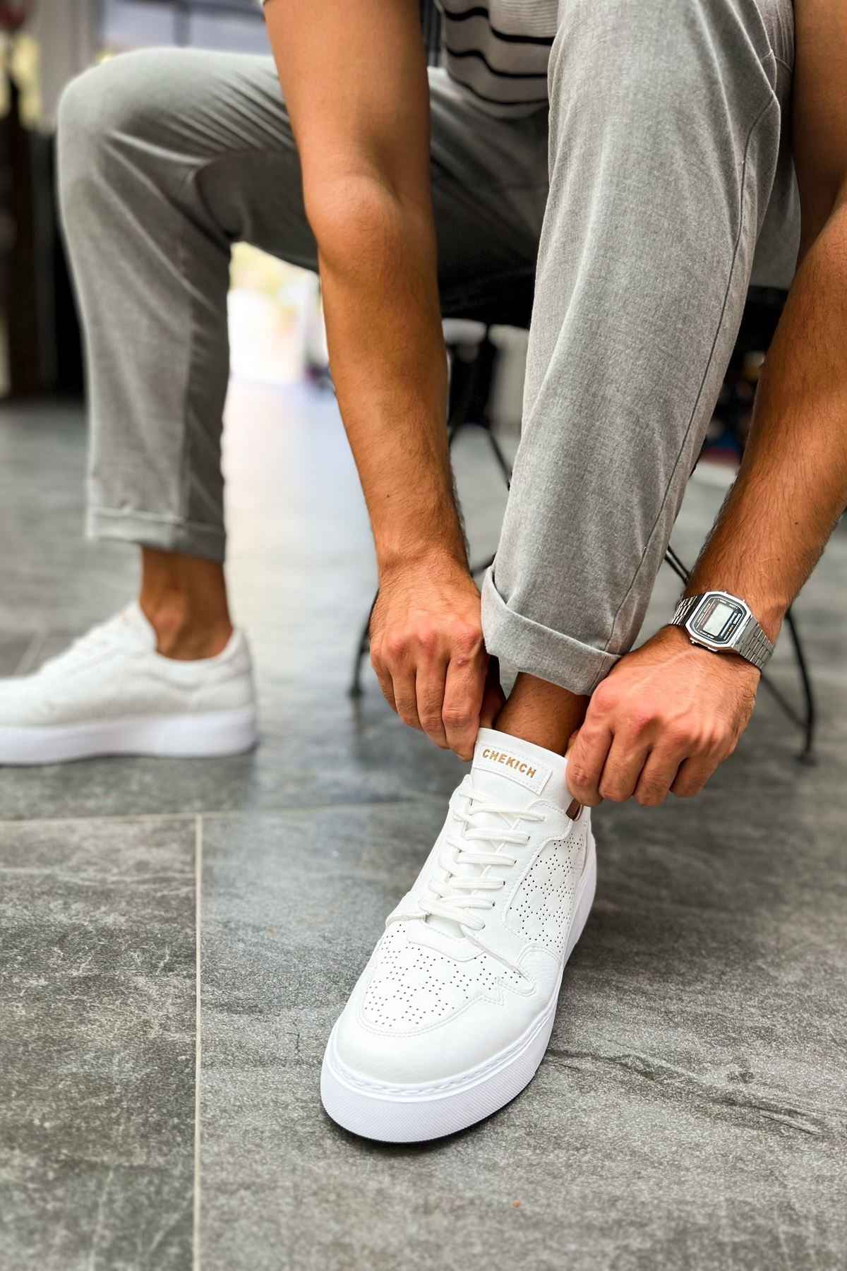 Men's white lace-up sneakers with perforated toe and cushioned collar