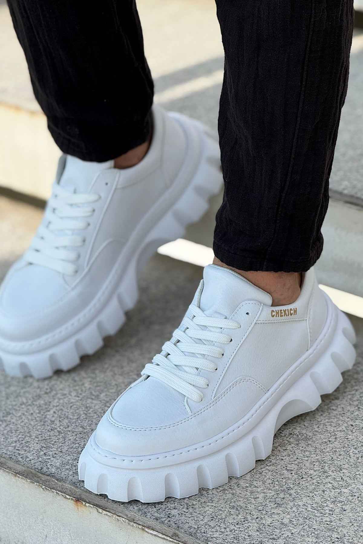 Men's white lace-up sneakers with side stitching and thick platform lug sole
