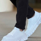 Men's white low-top sneakers with lace-up front and chunky white outsole