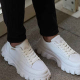 Men's white low-top sneakers, lace-up with thick lug sole and smooth leather upper