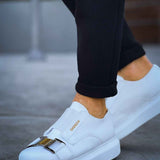 Men's white casual sneakers with double buckle strap, low-top design.
