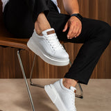 White lace-up sneakers, perforated toe, tan heel tab, low platform sole