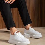 White sneakers on feet, lace-up design with tan heel tab and padded collar