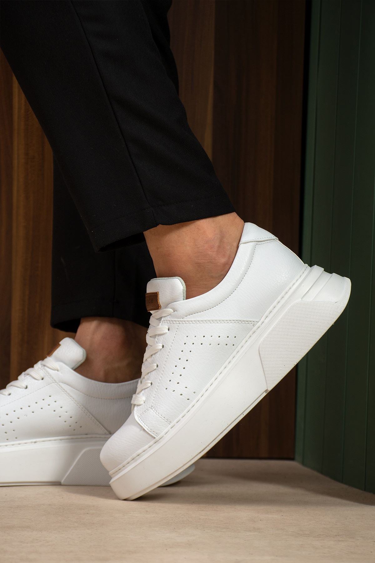 White low-top sneakers with lace closure and tan pull tab, side view