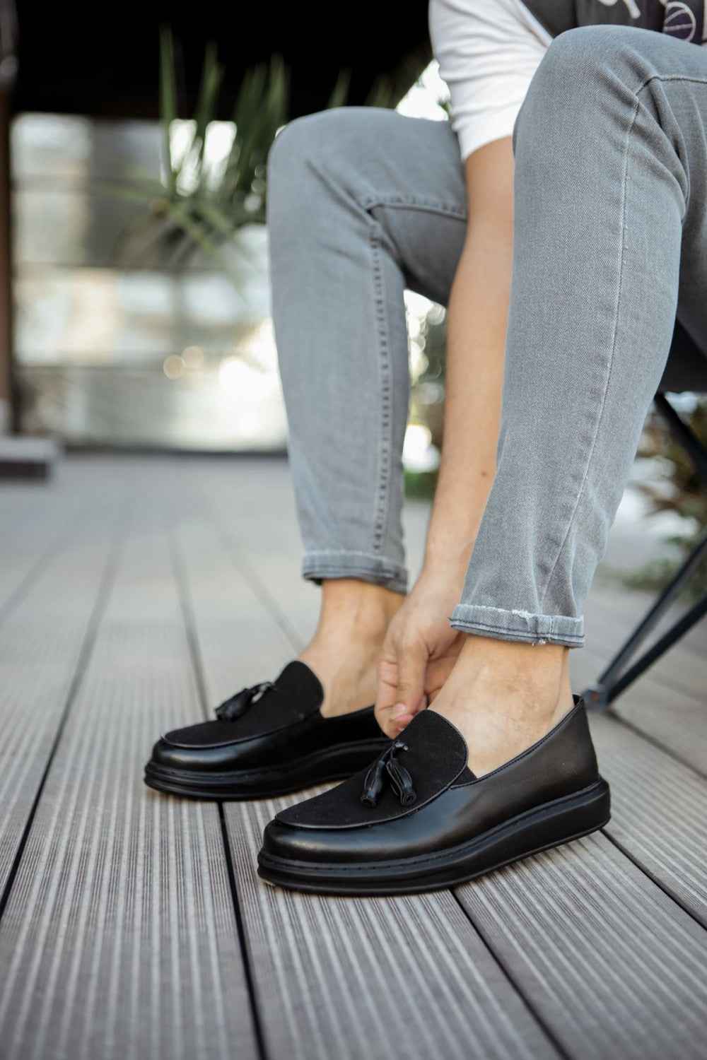 Men's black leather tassel loafers with slip-on vamp and low sole