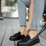 Men's black leather tassel loafers with slip-on vamp and low sole
