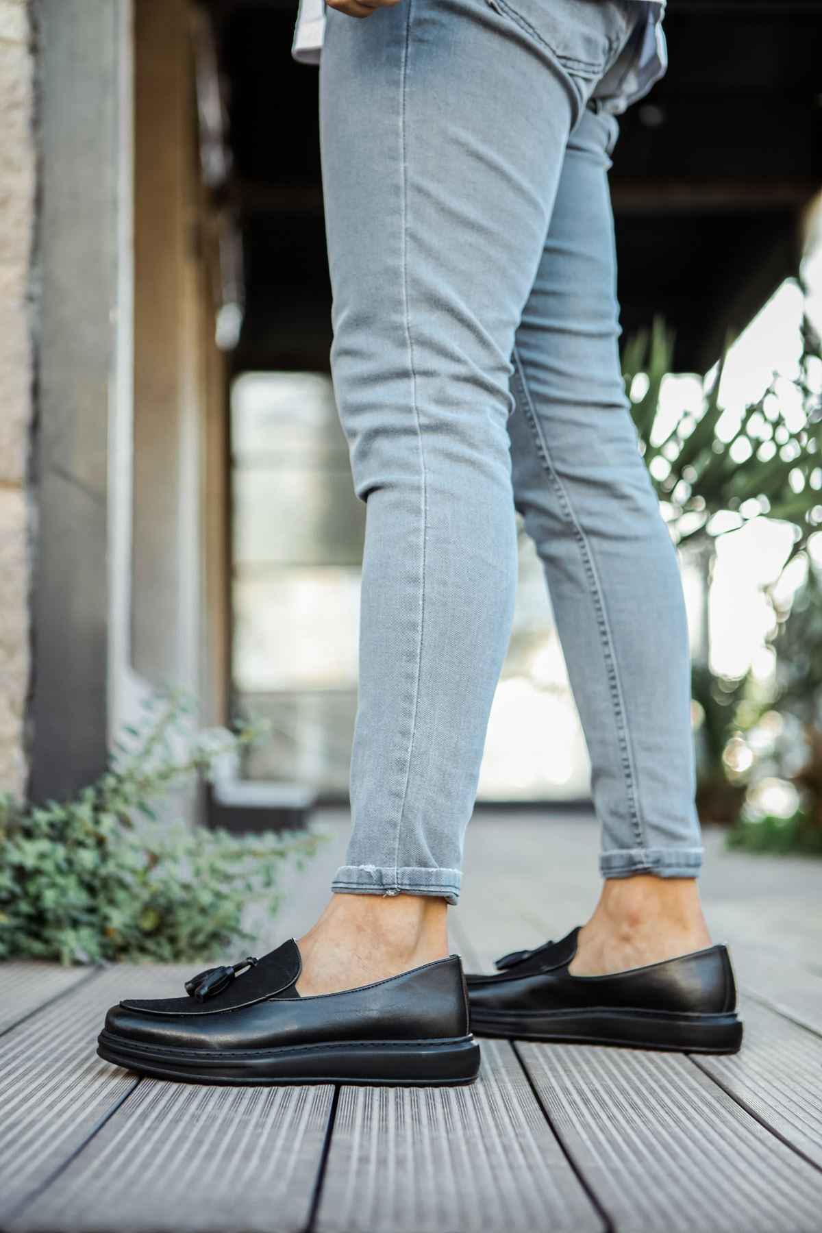 Men's black leather tassel loafers, paired view, low-profile sole