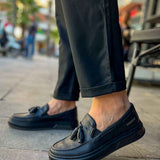 Men's black loafer with tassel detail, rounded toe and low profile.