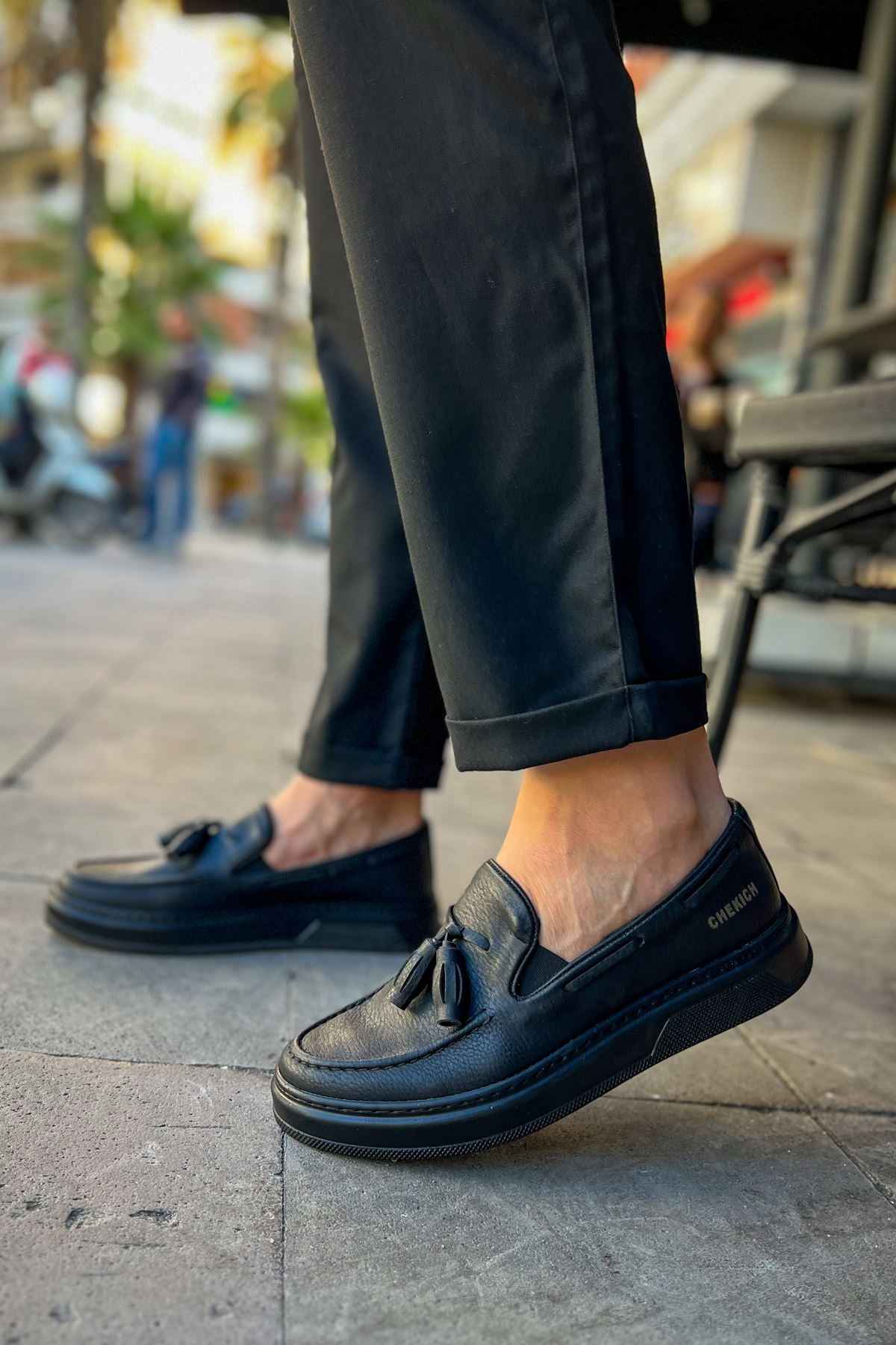 Men's black loafer with tassel detail, rounded toe and low profile.