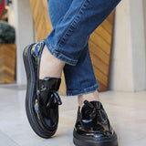 Men's black patent leather loafer with strap and rounded toe