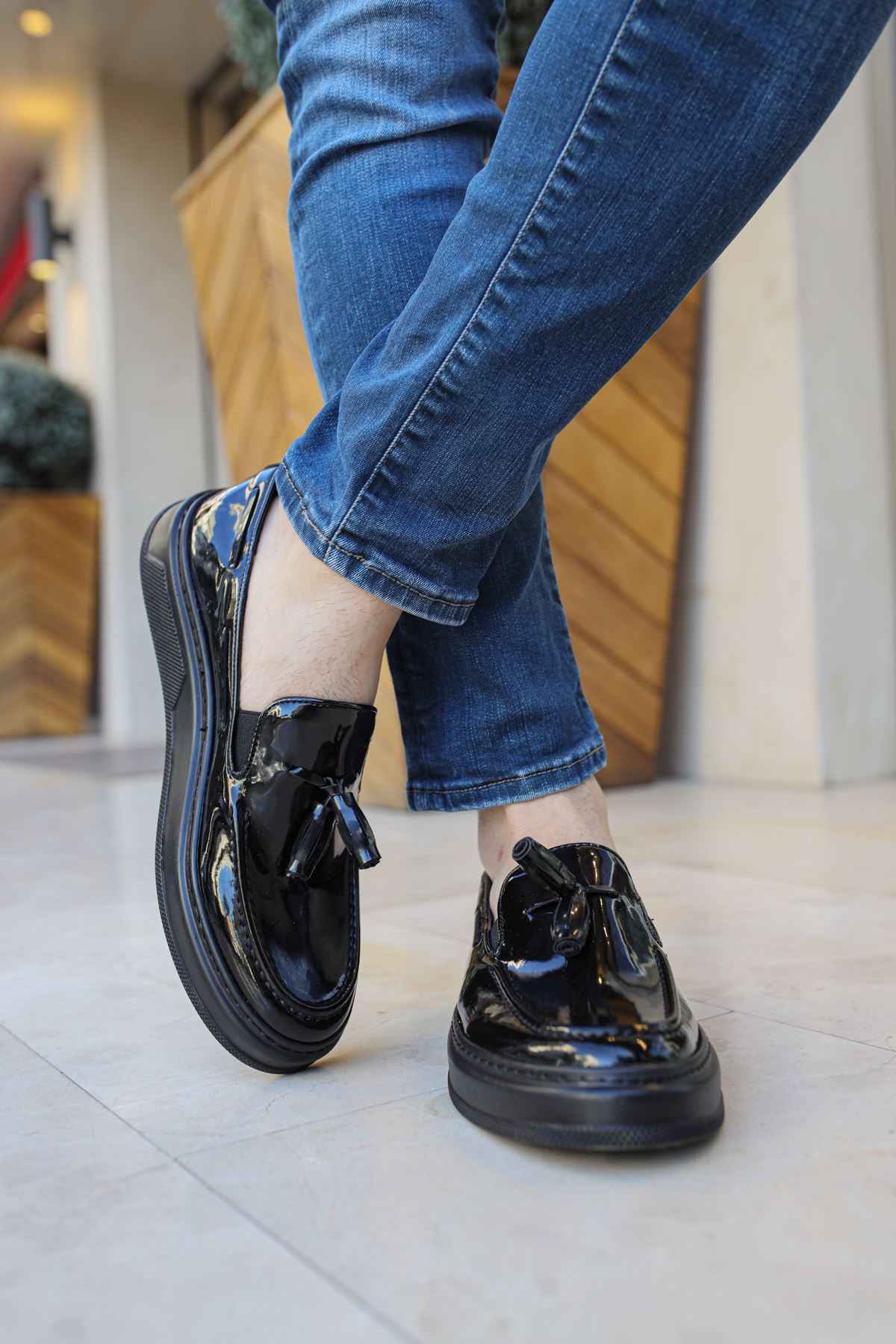 Men's black patent leather loafer with strap and rounded toe