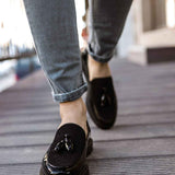 Black patent leather loafer, slip-on style with tassel and penny strap