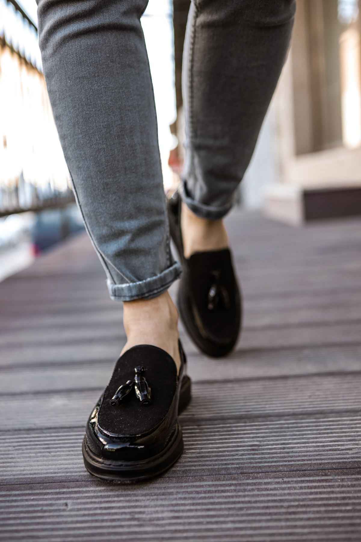 Black patent leather loafer, slip-on style with tassel and penny strap