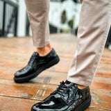 Men's black patent leather lace-up shoes with stitched apron and chunky sole