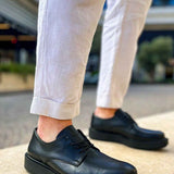 Black lace-up dress shoes with stitched upper and low-profile rubber sole