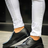 Men's classic black lace-up dress shoes, side view with low-profile sole